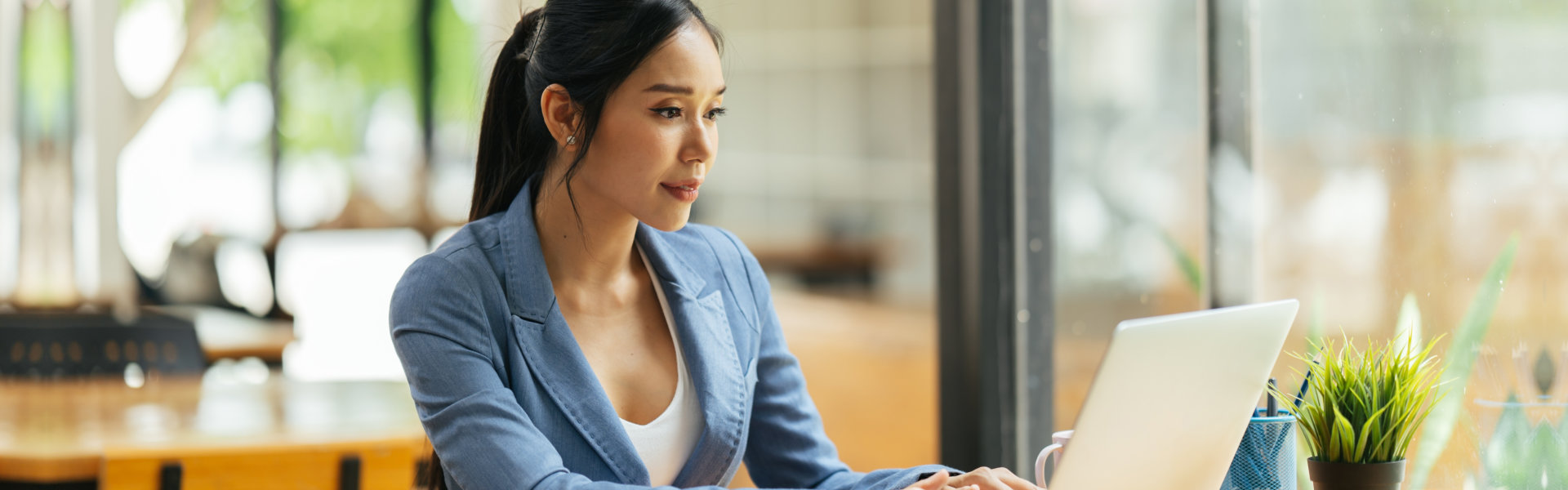 woman wearing formal attire and looking at the laptop