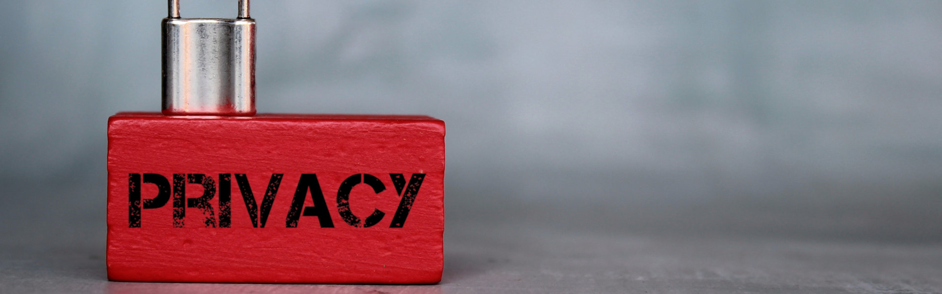 Close up image of padlock on wooden cube with text PRIVACY. Copy space for text